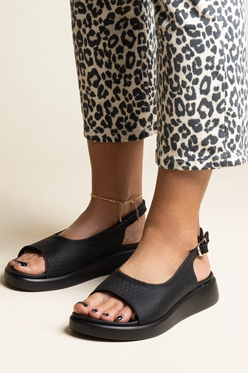 Black sandals on a block... 2