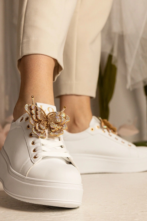 Białe sneakersy z motylkiem z... Białe sneakersy z motylkiem z...