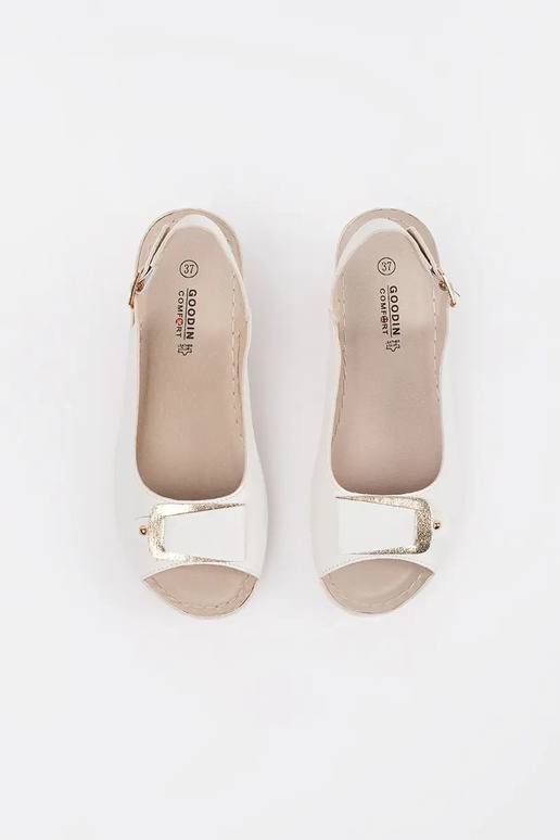 INhite color sandals on a loIn Inedge...