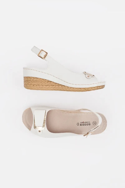 INhite color sandals on a loIn Inedge...