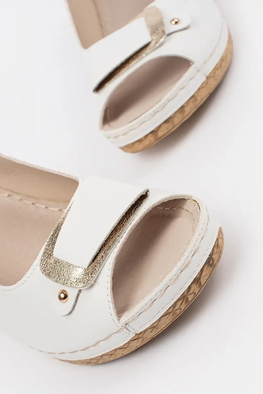 INhite color sandals on a loIn Inedge...