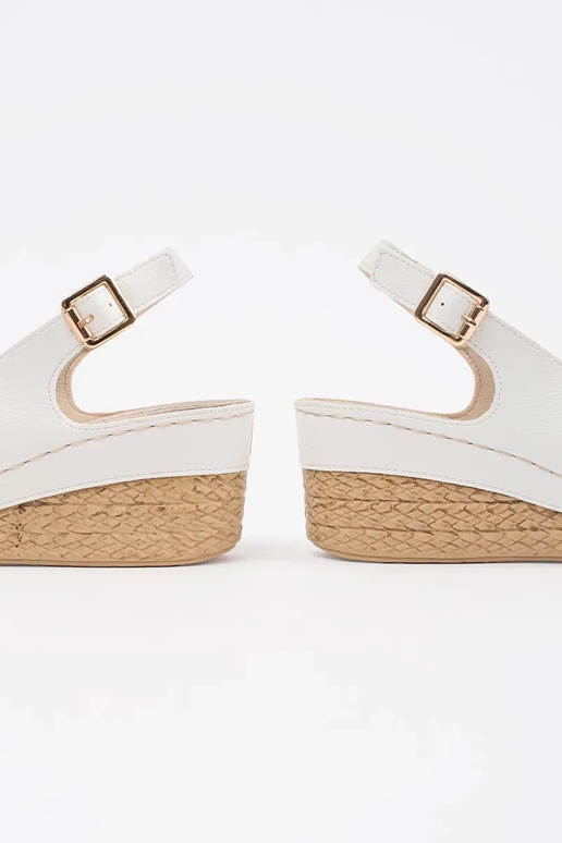 INhite color sandals on a loIn Inedge...