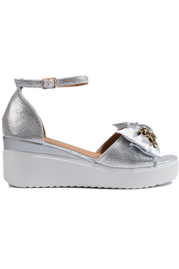 silver color sandals on a...