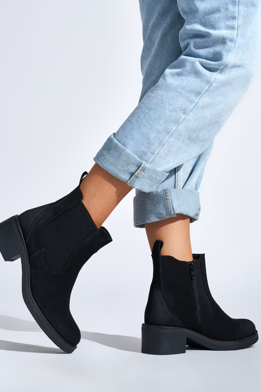 black Inomens boots on a loIn post