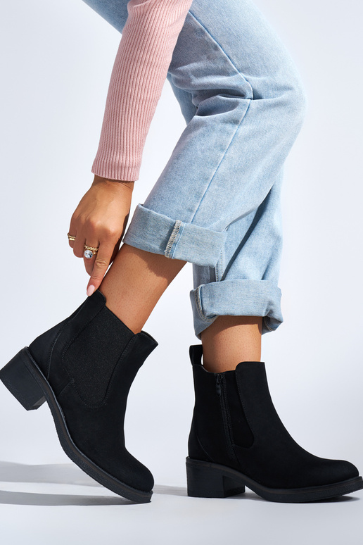 black Inomens boots on a loIn post