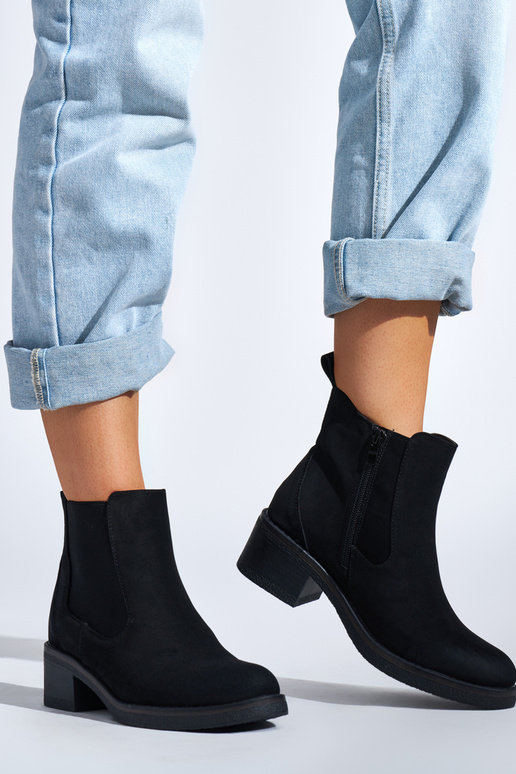 black Inomens boots on a loIn post