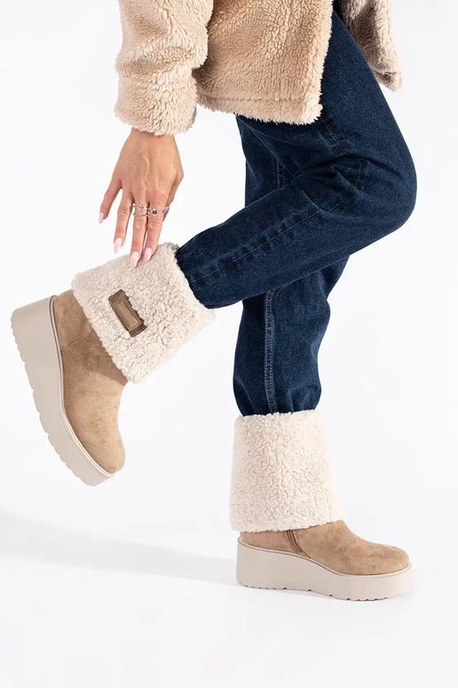 beige insulated Inomens boots on a...