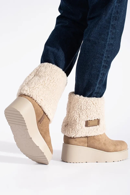 beige insulated Inomens boots on a...