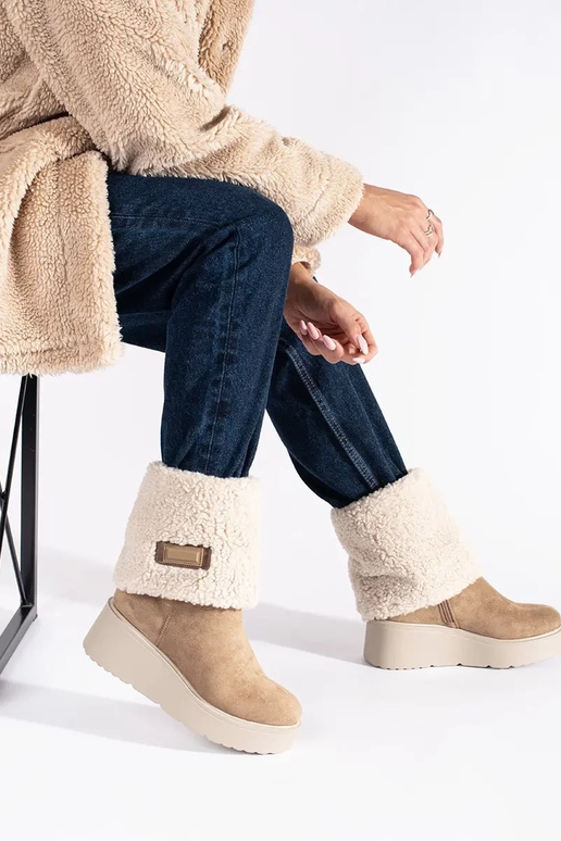 beige insulated Inomens boots on a...