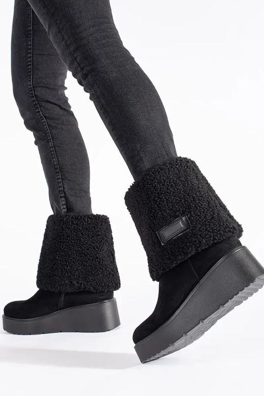 black insulated Inomens boots on a...