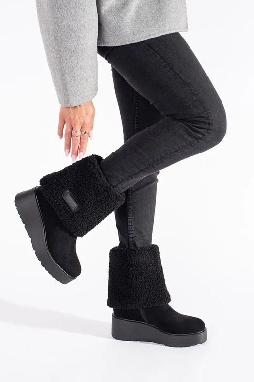 black insulated Inomens boots on a...