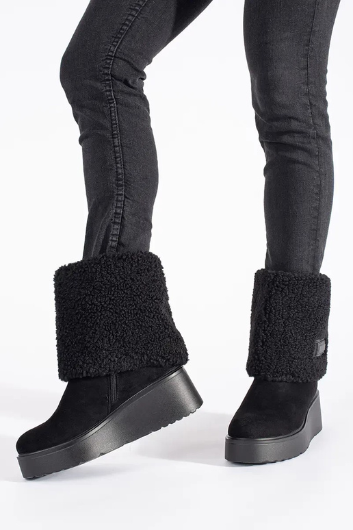 black insulated Inomens boots on a...