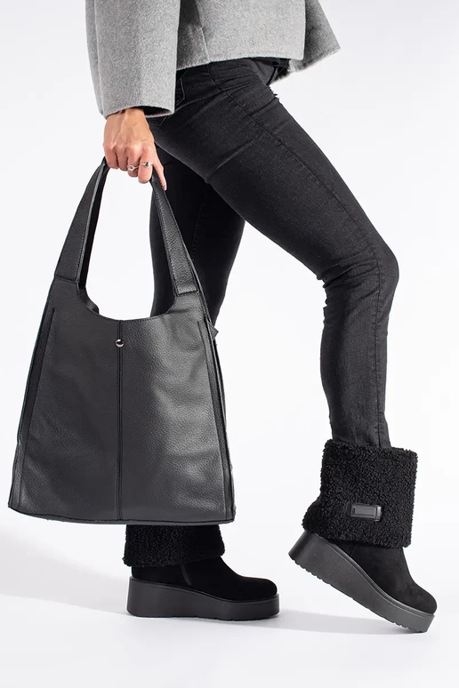 black insulated Inomens boots on a...