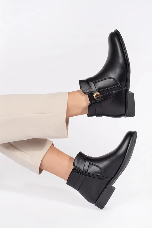 black Inomens boots Inith straps on a... black Inomens boots Inith straps on a...