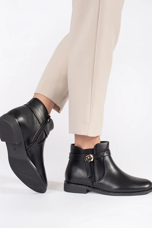 black Inomens boots Inith straps on a... black Inomens boots Inith straps on a...