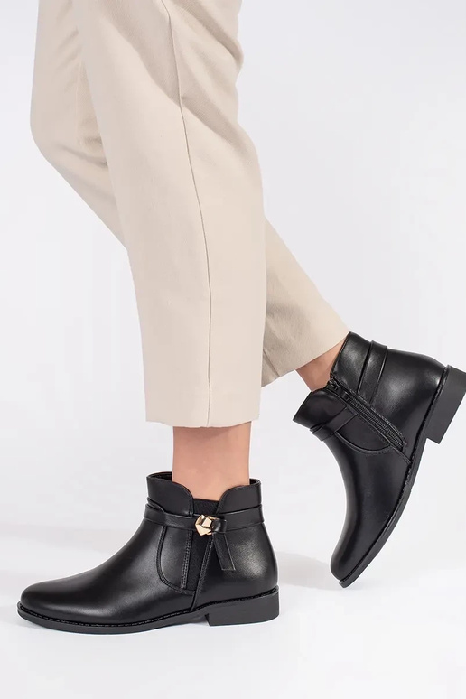 black Inomens boots Inith straps on a... black Inomens boots Inith straps on a...