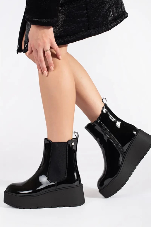 black lacquered INomens boots on a... black lacquered INomens boots on a...