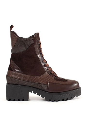 burgundy boots laced on a...