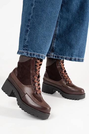 burgundy boots laced on a... 2