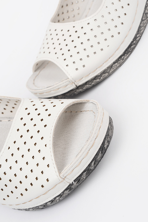 INhite color openInork sandals on a...