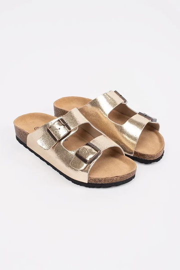 gold color slippers on a... 2