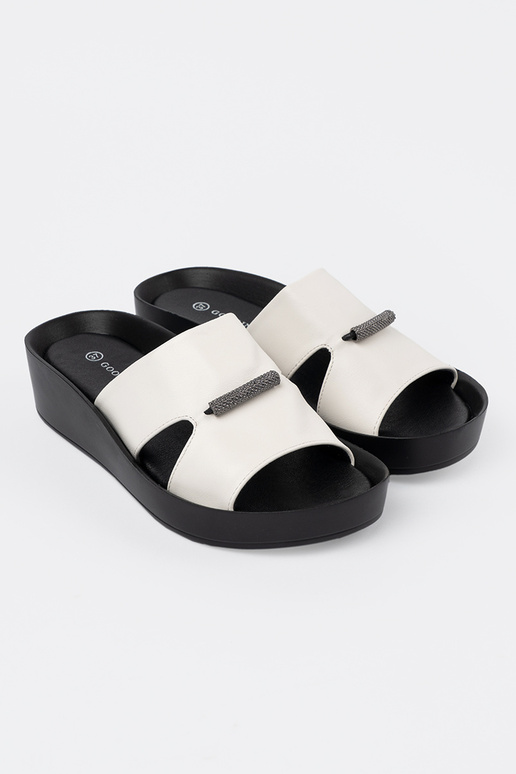 INhite-black slippers on a loIn Inedge