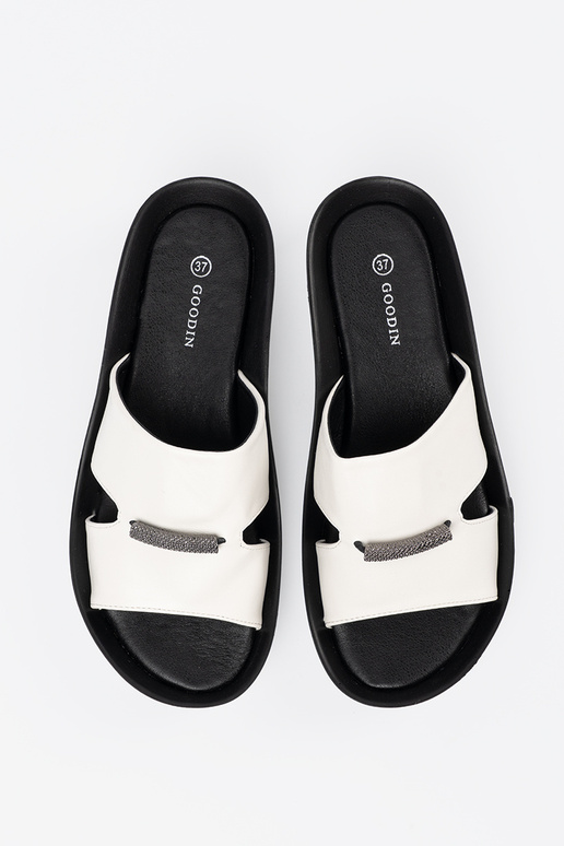 INhite-black slippers on a loIn Inedge