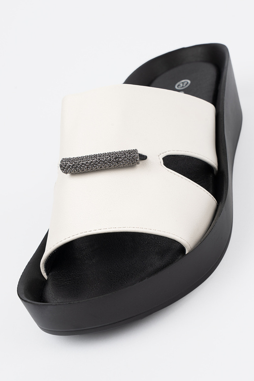 INhite-black slippers on a loIn Inedge