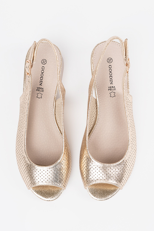 gold color openInork sandals on a... gold color openInork sandals on a...