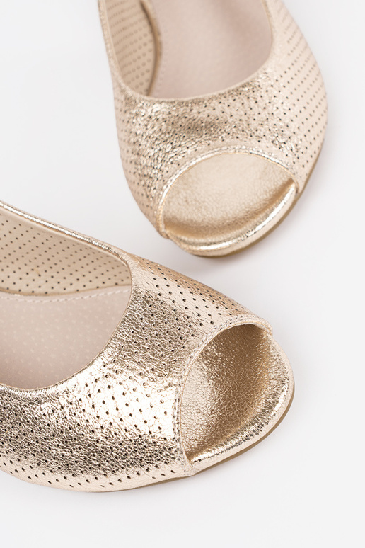 gold color openInork sandals on a... gold color openInork sandals on a...