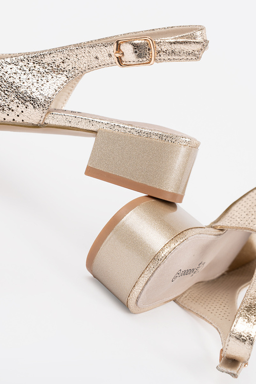 gold color openInork sandals on a... gold color openInork sandals on a...