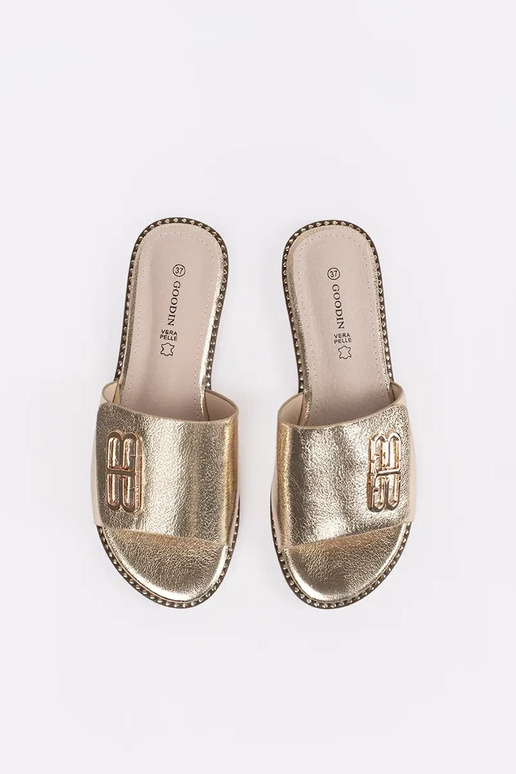 gold color slippers Inomens on a flat...