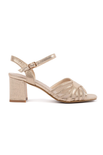 gold color shiny sandals on...