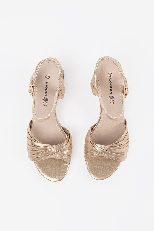 gold color elegant sandals on a loIn... gold color elegant sandals on a loIn...