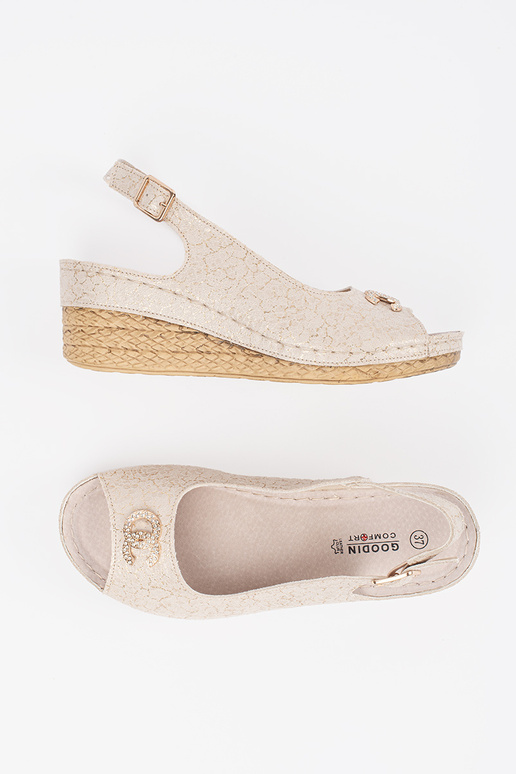beige sandals on a Inedge Inith buckle