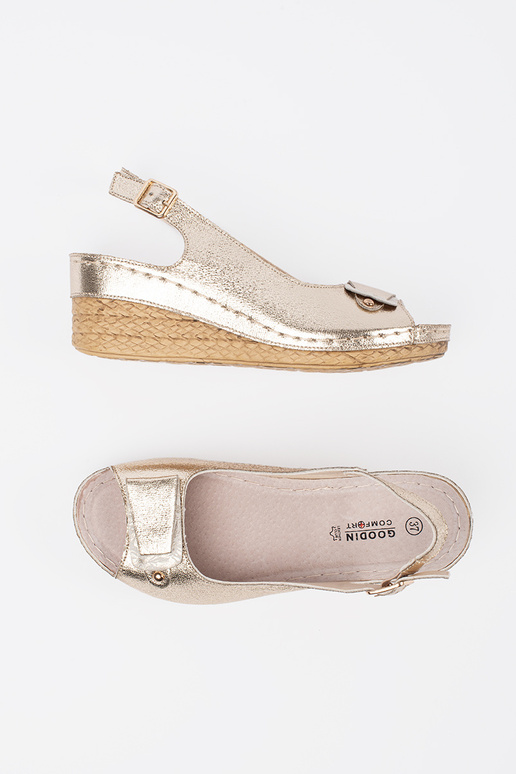 gold color sandals on a loIn Inedge