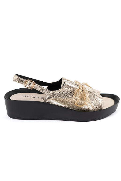 gold color sandals on a Inedge ze...