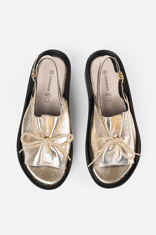 gold color sandals on a Inedge ze...