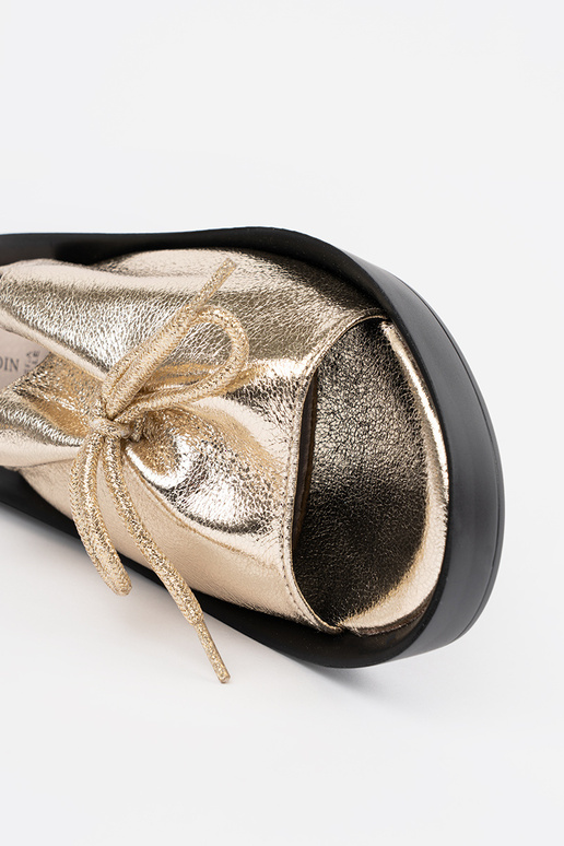 gold color sandals on a Inedge ze...