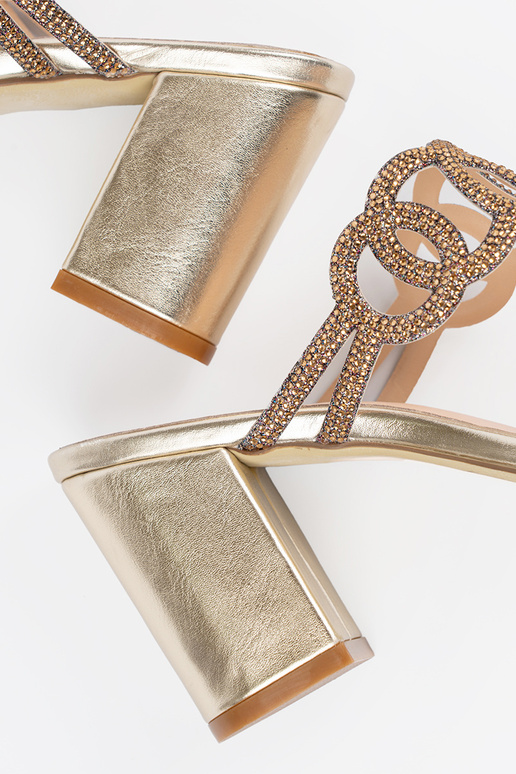 gold color slippers on the heel...