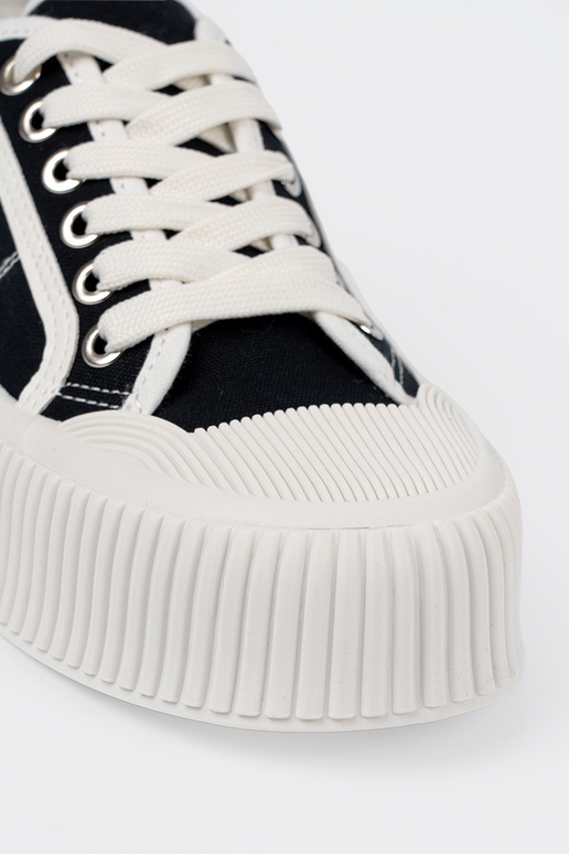 Black sports style shoes laced on a...