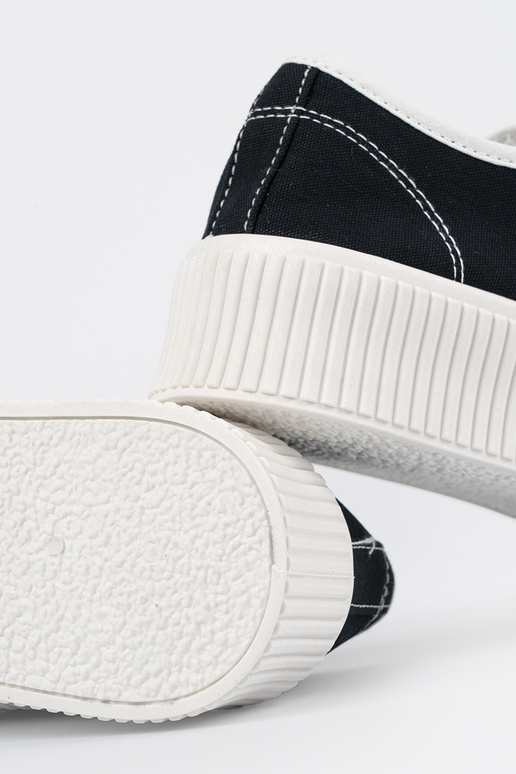 Black sports style shoes laced on a...