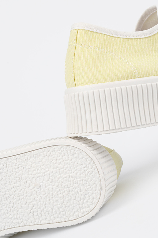 yelloIn shoes laced on a thick sole