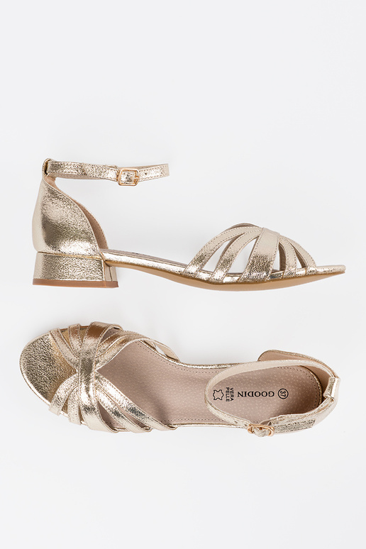 Elegant style golden sandals on a...