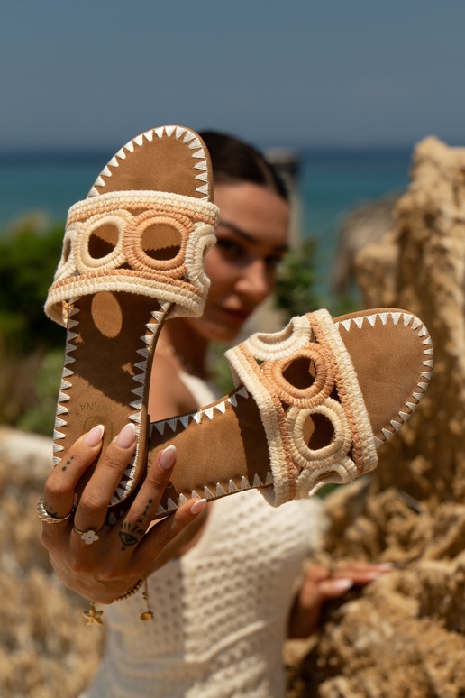 Crocheted women's slippers on a flat...