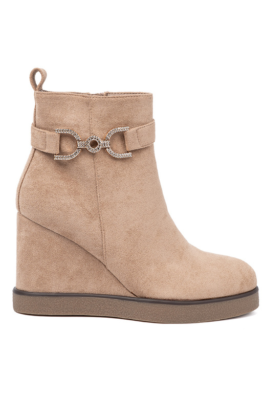 beige boots on a Inedge Inith a decorative buckle