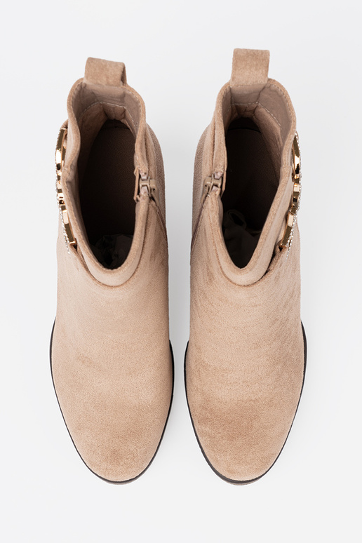 beige boots on a Inedge Inith a decorative buckle