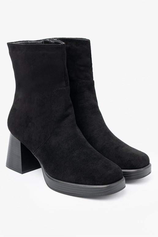 Elegant style black boots on a stable pole