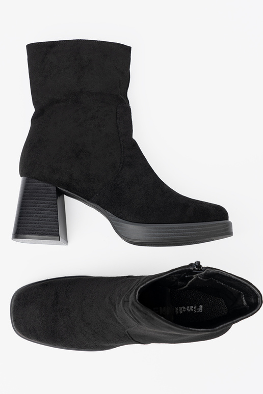 Elegant style black boots on a stable pole