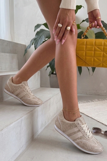 Sand colored sneakers with...